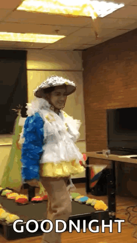 A Person In A Costume Says Goodnight In Front Of A Tv GIF