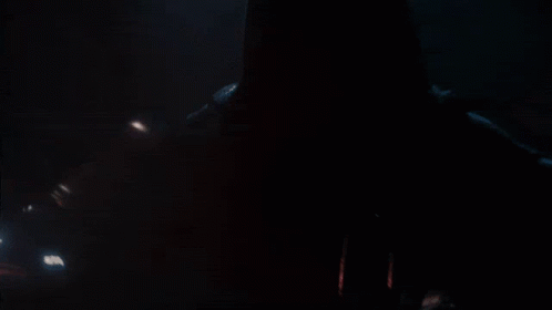 A Person In A Dark Room With A Red Light Coming Out Of Their Mouth GIF