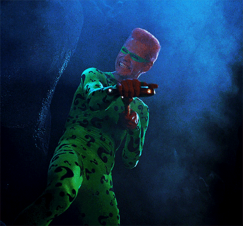 A Person In A Green Costume With A Question Mark On The Back GIF