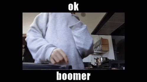 A Person In A Grey Sweatshirt Is Cooking In A Kitchen And The Caption Says Boomer GIF