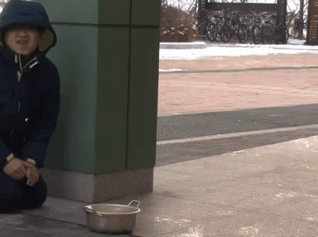 Person In Hooded Jacket Sitting Next To Bowl GIF