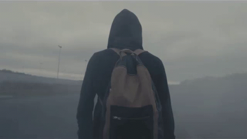 a person in a hooded jacket with a backpack