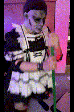A Person In A Maid Costume Holding A Green Stick GIF