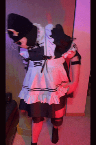 A Person In A Maid Costume Is Standing In A Room With Red Lights GIF