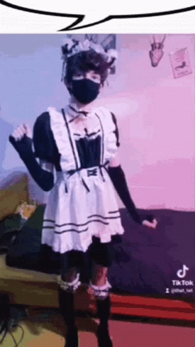 A Person In A Maid Costume Is Wearing A Mask . GIF
