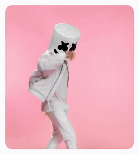 A Person In A Marshmallow Costume Is Standing On A Pink Background . GIF