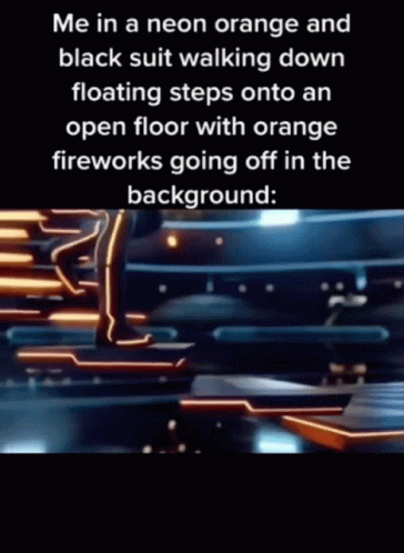 A Person In A Neon Orange And Black Suit Is Walking Down Floating Steps Onto An Open Floor With Orange Fireworks Going O GIF
