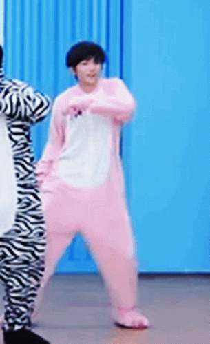 A Person In A Pink Zebra Costume Is Dancing GIF