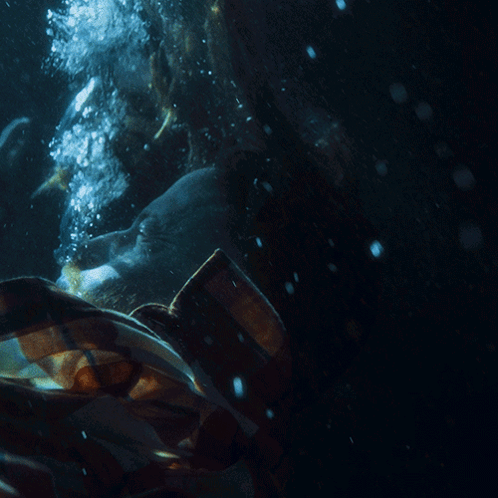 A Person In A Plaid Shirt Is Underwater With Bubbles Coming Out Of Their Mouth GIF