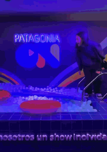 A Person In A Pool With The Word Patagonia On The Wall GIF