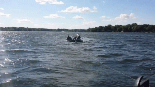 A Person In A Raft Is Floating On A Body Of Water GIF