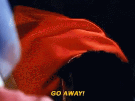 A Person In A Red Cape Says Go Away In Yellow Letters GIF