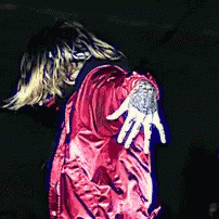 A Person In A Red Jacket With A Tattoo On Their Shoulder GIF