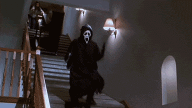 a person in a scream mask is walking down stairs .