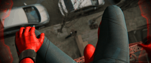 A Person In A Spiderman Costume Is Sitting On A Balcony GIF