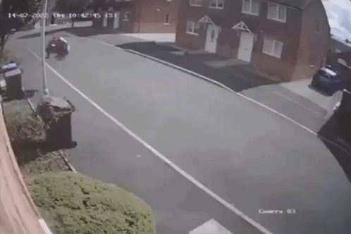 A Person In A Spiderman Costume Is Standing On The Side Of The Road . GIF