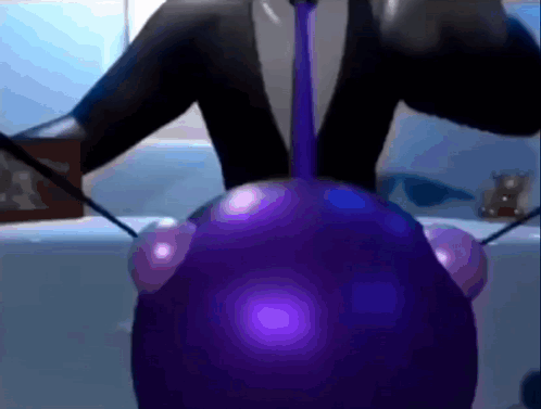 A Person In A Suit And Tie Is Holding A Purple Object GIF