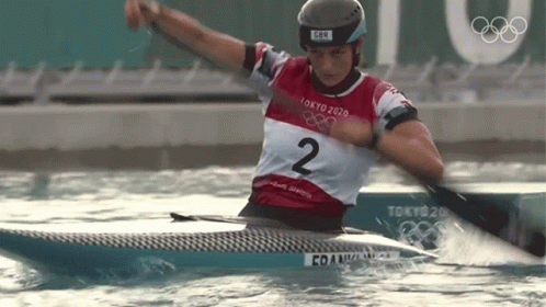 A Person In A Tokyo 2020 Shirt Is Paddling A Kayak GIF