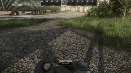 A Person In A Video Game Is Holding A Bullet In Their Hand In Front Of A Truck That Says " Paradox " GIF
