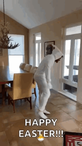 A Person In A White Bunny Suit Is Dancing In A Living Room . GIF
