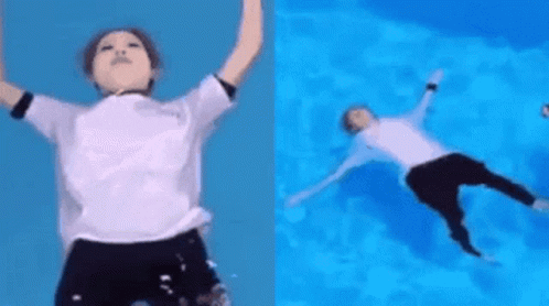 A Person In A White Shirt Is Jumping Into A Pool Of Water . GIF