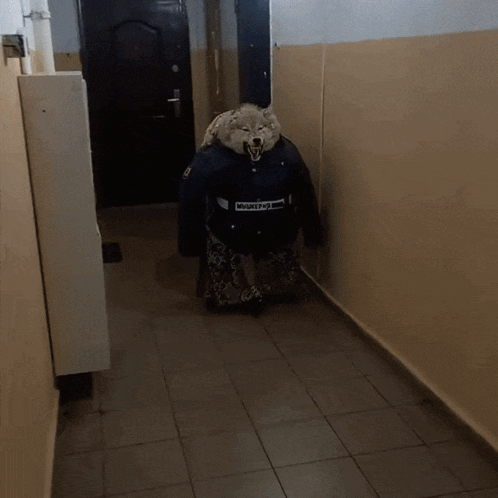 A Person In A Wolf Costume Is Walking Down A Hall GIF