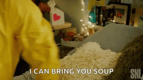 A Person In A Yellow Jacket Is Laying On A Bed And Says I Can Bring You Soup GIF