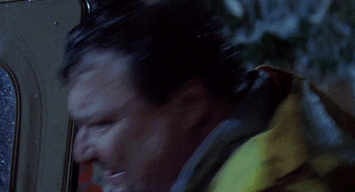 a person in a yellow raincoat is standing in the rain