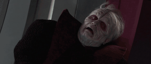 A Person Is Being Struck By A Lightning Bolt In A Dark Room . GIF