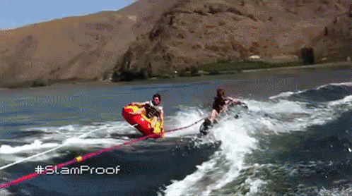 A Person Is Being Towed By A Boat In The Water With The Hashtag Slamproof GIF