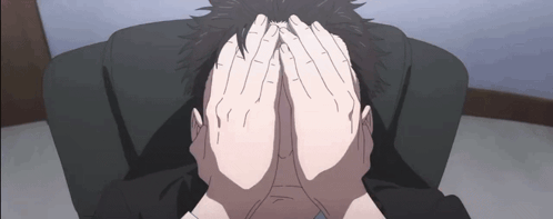 A Person Is Covering Their Face With Their Hands While Sitting In A Chair . GIF