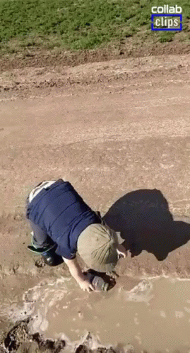 A Person Is Crawling Through A Muddy Puddle With A Collab Clips Logo In The Corner GIF