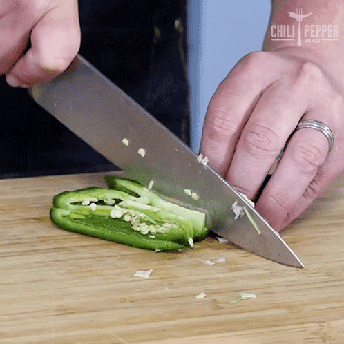 A Person Is Cutting A Jalapeno Pepper On A Wooden Cutting Board With Chili Pepper Written On The Bottom GIF