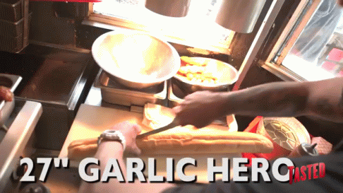 A Person Is Cutting A Loaf Of Bread With The Words 27 " Garlic Hero Master On The Bottom GIF