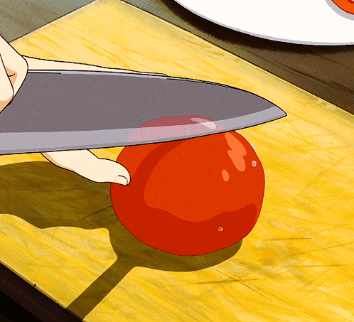 Person Cutting Tomato With Large Knife GIF