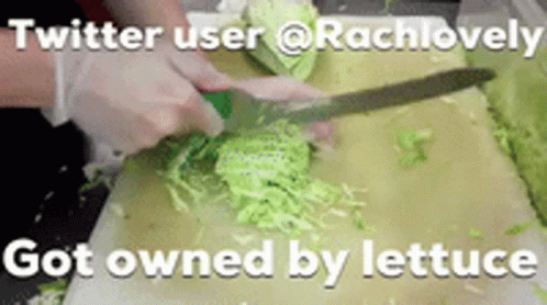 A Person Is Cutting Lettuce On A Cutting Board With A Knife . GIF