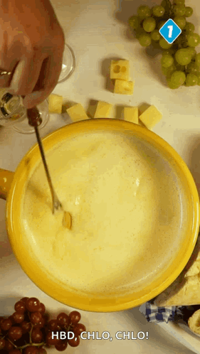 A Person Is Dipping A Piece Of Cheese Into A Bowl Of Fondue GIF