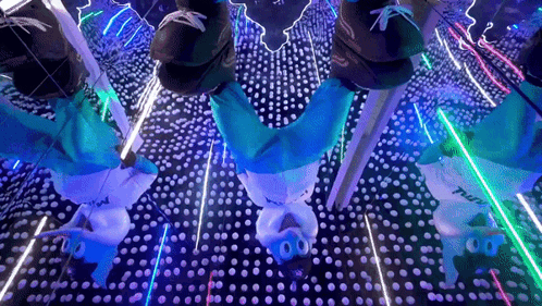 A Person Is Doing A Handstand In A Room With A Lot Of Lights GIF