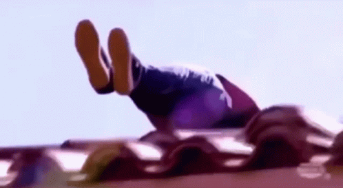 A Person Is Doing A Handstand On A Roof With Their Feet Up In The Air . GIF