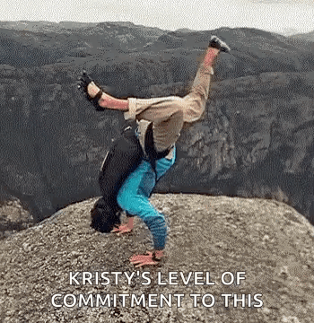 A Person Is Doing A Handstand On Top Of A Rocky Cliff . GIF