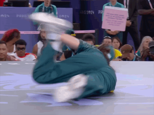 A Person Is Doing A Trick In Front Of A Sign That Says ' Paris 2024 ' On It GIF