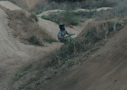 A Person Is Doing A Trick On A Bike While Wearing A Helmet With A Skull And Crossbones On It GIF