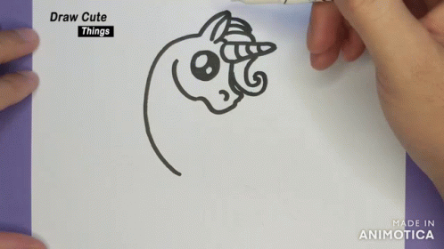A Person Is Drawing A Unicorn On A Piece Of Paper With A Marker GIF