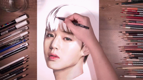 A Person Is Drawing A Woman 'S Face With Colored Pencils And Markers GIF