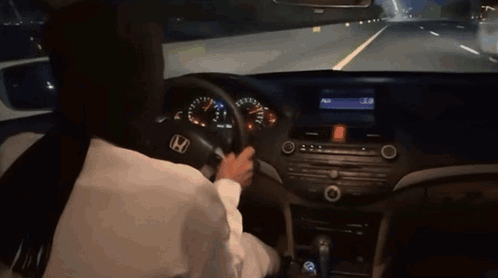 A Person Is Driving A Honda Car On A Highway GIF