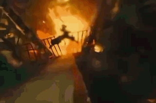 A Person Is Falling From A Balcony Into A Fire . GIF