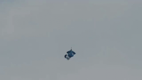 A Person Is Falling From A Parachute That Says Red Bull GIF
