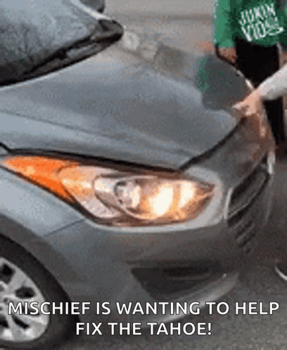 A Person Is Fixing A Car With The Caption Mischief Is Wanting To Help Fix The Tahoe . GIF