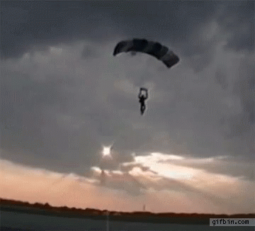 a person is flying through the air with a parachute and the website gifbin.com is visible in the corner