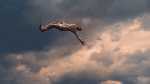 A Person Is Flying Through The Air With A Sword In Their Hand GIF